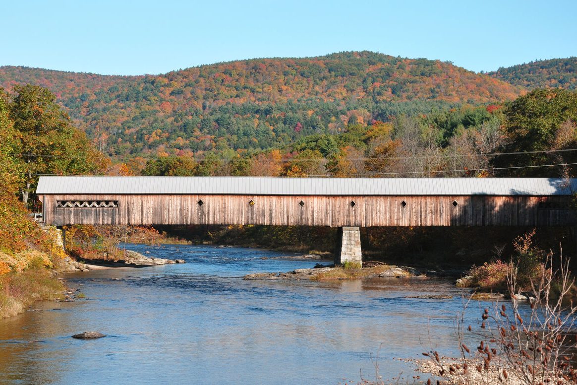 A covered bridge surrounded by autumn foliage in central Vermont.