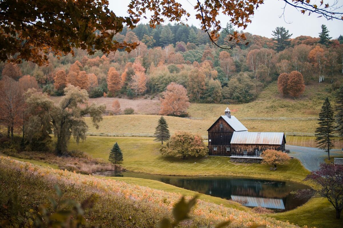 A Vermont river flanked by peak fall foliage.